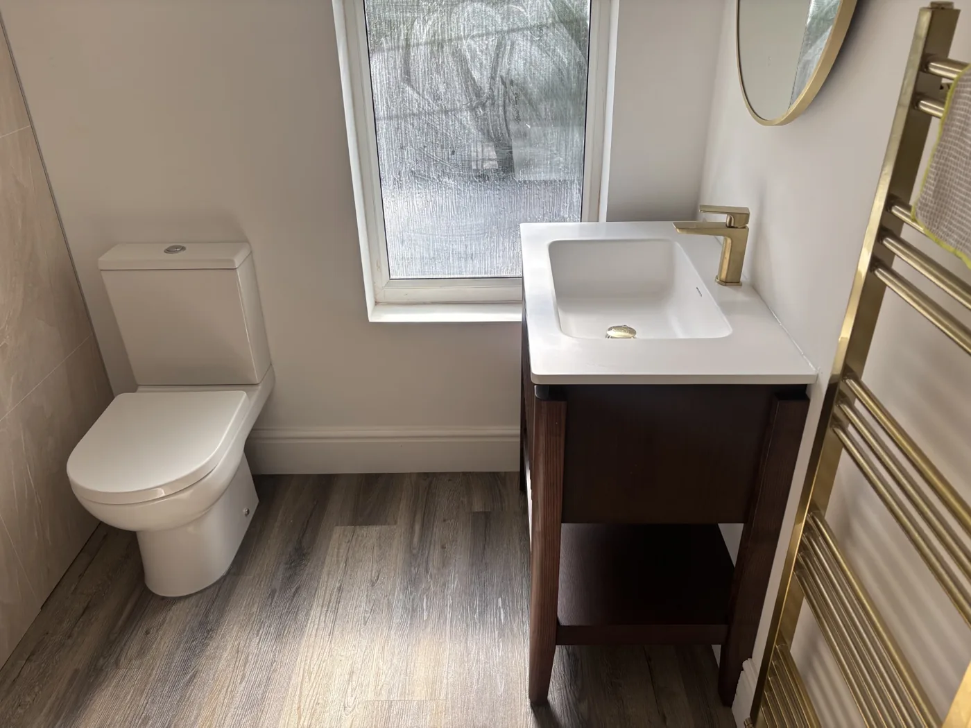 Completed bathroom installation with basin and toilet