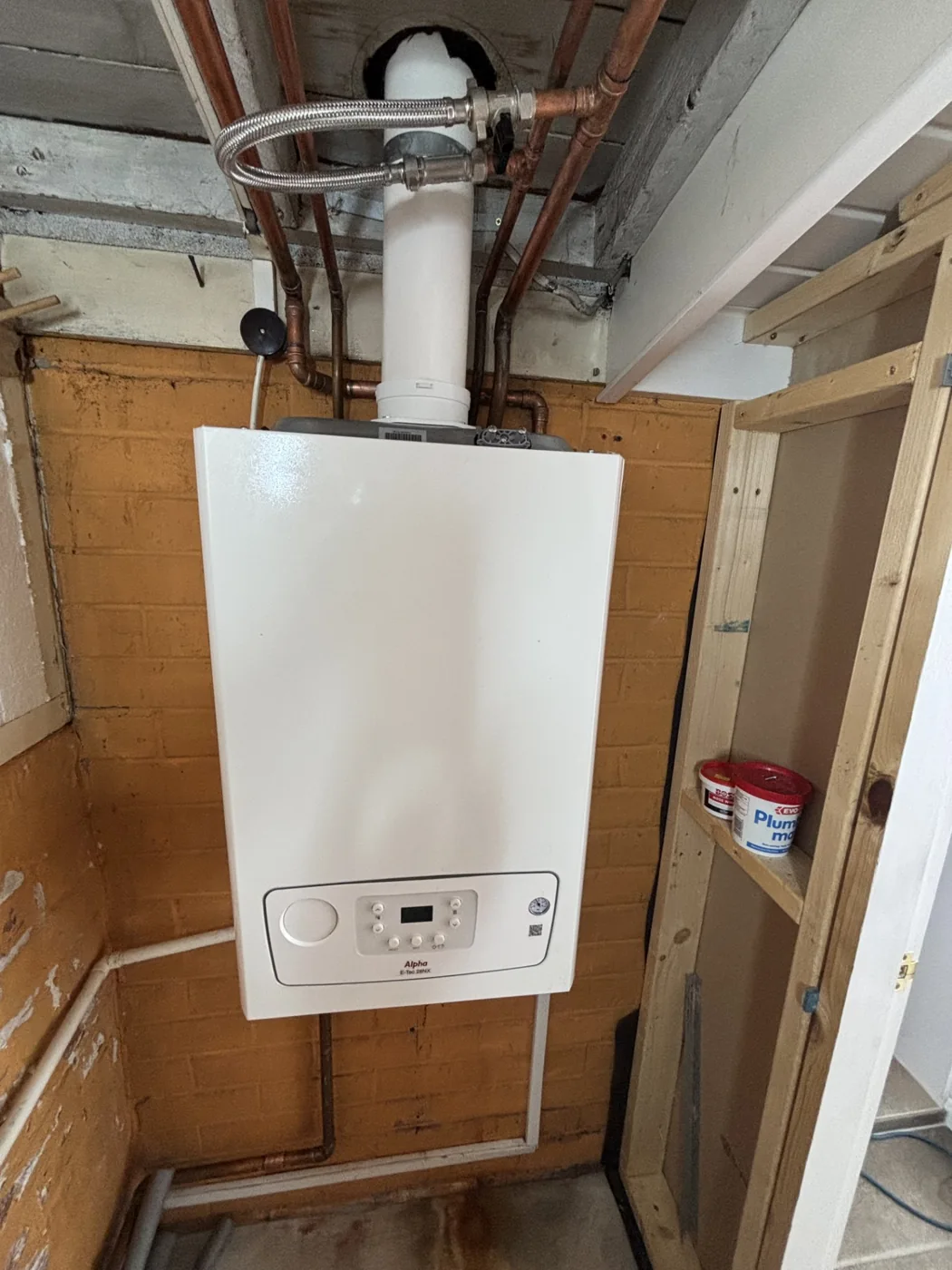 Boiler fitted with pipework in a utility area